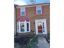 Charming brick home with a bay window and red door, complemented by colorful shutters and a well-maintained walkway at 5012 Jenny Dr, Acworth, GA 30101