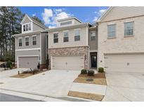 Charming townhome exterior with brick accents, neutral siding, and attached two-car garage at 871 Dunning St, Marietta, GA 30060