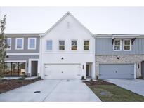 Newly constructed townhomes with a mix of painted brick and siding exteriors, complemented by well-maintained lawns at 205 Admor Ln, Acworth, GA 30102