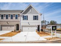 New construction townhome with neutral siding, gray shutters, and a two-car garage at 417 Carrera Ln, Acworth, GA 30102