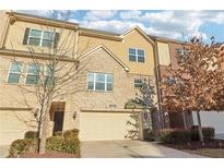 Attractive townhome boasts brick and siding details, a one car garage and well-maintained landscaping at 1904 Glen Ivy # 19, Marietta, GA 30062