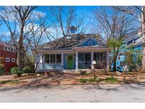 Charming blue home featuring a cozy front porch and a vibrant green front door at 306 Arizona Ne Ave, Atlanta, GA 30307