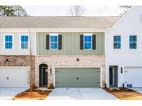 Charming townhouse with a mix of brick and siding exterior, featuring a two-car garage at 408 Carrera Ln, Acworth, GA 30102