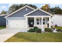 Charming single-story home with gray siding, white trim, a two-car garage, and a welcoming front porch at 790 Riverwood Pass, Dallas, GA 30157