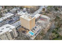Stunning aerial view showcases building with a pool, parking and river views, close to traffic routes and shopping at 2285 Peachtree Ne Rd # 1107, Atlanta, GA 30309