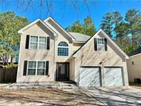 Charming two-story home with a two car garage and a well-manicured front yard at 5175 Bridle Point Pkwy, Snellville, GA 30039