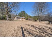 Charming single-story home with a front yard, mature trees, and a welcoming facade at 4065 Thaxton Rd, Atlanta, GA 30349