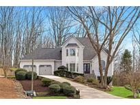 Charming home with a three car garage, well-manicured landscaping, and a walkway to the front door at 4170 Summit Way, Marietta, GA 30066