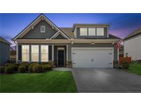 Charming home featuring a two-car garage, well-manicured lawn, and neutral exterior paint at 4645 Dandelion Way, Cumming, GA 30040