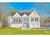 Charming white home with a lovely front porch and a well-manicured lawn at 1337 M L King Jr Nw Dr, Atlanta, GA 30314