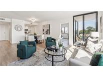 Bright living room with modern decor, balcony access, and hardwood floors at 3481 Lakeside Ne Dr # 1602, Atlanta, GA 30326