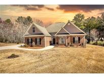 Beautiful brick home with well-manicured lawn and inviting entrance, perfect for a Gathering at 75 Horseshoe Dr, Covington, GA 30014