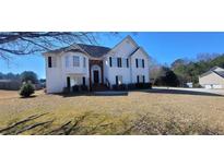 Charming two-story home with black shutters and a well-manicured lawn at 903 Tucker Ln, Loganville, GA 30052