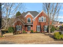 Charming brick two-story home featuring manicured landscaping and inviting curb appeal at 2705 Riderwood Pl Ne, Marietta, GA 30062