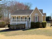 Charming single-Gathering home with a cozy front porch and well-maintained landscaping at 1501 Quail Run, Auburn, GA 30011
