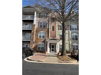 Charming condo building with well-maintained landscaping and inviting entryway at 1965 Nocturne Dr # 1103, Alpharetta, GA 30009