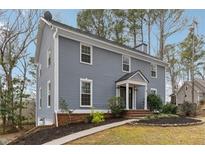 Charming two-story home featuring a well-maintained lawn, a cozy entrance, and classic architectural details at 710 Melanie Ct, Canton, GA 30115