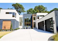 Striking modern home featuring a sleek design, multi-car garage and a spacious driveway, perfect for contemporary living at 2480 Pangborn Cir, Decatur, GA 30033
