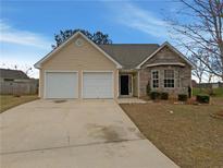 Charming single-Gathering home with stone accents, a two-car garage, and a well-maintained lawn at 40 Zebulon Pl, Covington, GA 30016