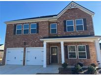 Charming two-story brick home with a two-car garage and a covered front porch, offering curb appeal at 1224 Hibiscus Way, Mcdonough, GA 30253