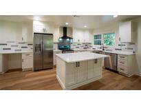 Bright kitchen with white cabinets, stainless steel appliances, island and modern countertops at 1342 Carter Rd, Decatur, GA 30030