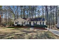 Charming single-story home featuring a well-maintained lawn and classic architectural details at 2405 Jack Creek Sw Rd, Marietta, GA 30008