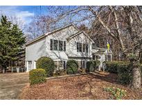 Charming two-story home with well-maintained landscaping, mature trees, and a welcoming front entrance at 2033 Old Newnan Rd, Carrollton, GA 30116
