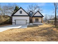 Charming new construction home with a covered porch, craftsman details, and an attached garage at 4374 Westside Nw Dr, Acworth, GA 30101