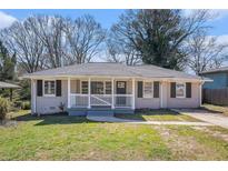 Charming single-story home featuring a cozy front porch and well-maintained lawn at 2753 Wedgewood Ter, Decatur, GA 30032