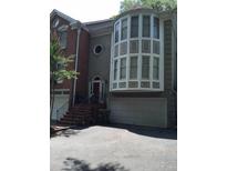Unique two story home features a prominent bay window and classic brick and stucco finishes at 871 Embassy Ne Ct, Atlanta, GA 30324