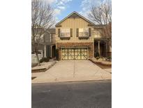 Charming two-story home with a two-car garage and an inviting stone facade and well-maintained driveway at 2530 Gold Creek Ln, Cumming, GA 30041