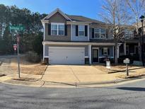 Charming two-story home with a two-car garage, a well-manicured lawn, and a welcoming front porch at 801 Rutledge Ct, Woodstock, GA 30188