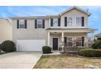 Charming two-story home with a well-manicured front yard and a two-car garage, perfect for a Gathering at 2011 Farm Hill Ct, Stockbridge, GA 30281