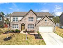 Charming two-story brick home with manicured lawn and inviting curb appeal at 3663 Thackary Dr, Powder Springs, GA 30127