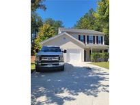 Charming two-story home with an attached garage and well-maintained lawn at 10221 Deep Creek Pl, Union City, GA 30291