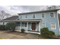 Charming two-story home featuring a welcoming front porch and light blue siding at 3430 Pate Rd, Snellville, GA 30078