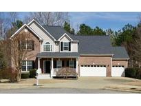 Charming two-story brick home with a manicured lawn and a three-car garage at 1008 Fountain Lks, Lawrenceville, GA 30043