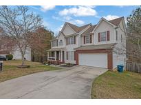 Charming two-story home with a two-car garage and manicured front lawn at 1514 Log Cabin Ln, Lawrenceville, GA 30045