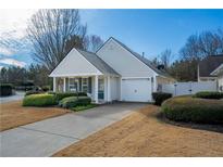 Charming single-story home with manicured lawn and attached two-car garage at 1905 Cottage Grove Way, Cumming, GA 30040