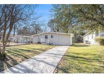 Charming single-story home featuring a well-maintained lawn, inviting walkway, and freshly painted exterior at 2917 1St Sw Ave, Atlanta, GA 30315