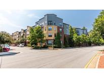 Attractive condo building with colorful exterior, mature trees, and street view at 400 17Th Street Nw # 1304, Atlanta, GA 30363