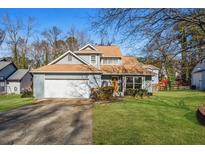 Charming two-story home with a well-manicured lawn, attached garage, and inviting front entrance at 981 Cobb Place Manor Dr, Marietta, GA 30066