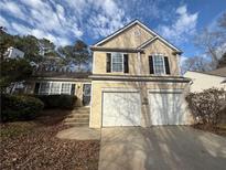 Inviting two-story home with a two-car garage and well-maintained front yard and beautiful sky view at 214 Creel Chase Nw, Kennesaw, GA 30144