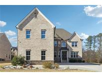 Two-story brick home with a well-manicured front lawn and a classic architectural design at 5095 Five Forks Trickum Sw Rd, Lilburn, GA 30047