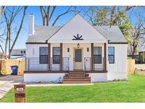Charming renovated home boasts fresh white paint, modern porch railing, and beautifully manicured lawn at 264 Haas Ave, Atlanta, GA 30316