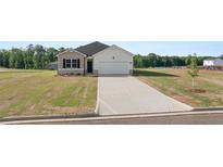 Charming single-story home featuring a wide driveway and attached garage on a large lawn at 8599 Secretariat Dr, Lithonia, GA 30058