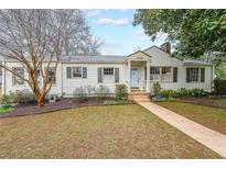 Charming single-story home with light siding, walkway and dark shutters at 2726 Craigie Ave, Decatur, GA 30030