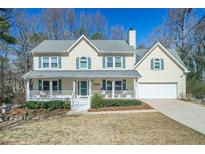 Charming two-story home with a welcoming front porch, neat landscaping, and an attached two-car garage at 2950 Scenic Lake Ct, Lawrenceville, GA 30045