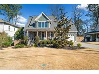 Charming home with a stone facade, green accent colors, mature landscaping and a well-maintained lawn at 3132 Skyland Ne Dr, Atlanta, GA 30341