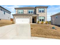 Charming two-story home featuring brick accents, a two-car garage, and well-maintained landscaping at 4779 Mock Orange Sw St, Atlanta, GA 30331